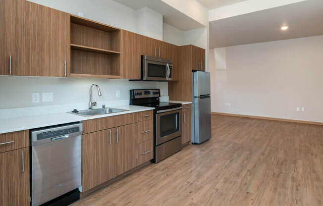 Kitchen with Stainless Steel Appliances, Quartz Counters and Hard Surface Flooring