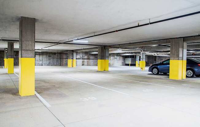 Underground parking lot at the modern apartment complex, featuring state-of-the-art electric vehicle chargers. A well-lit and spacious area with designated charging stations, ensuring convenience for residents with electric cars.