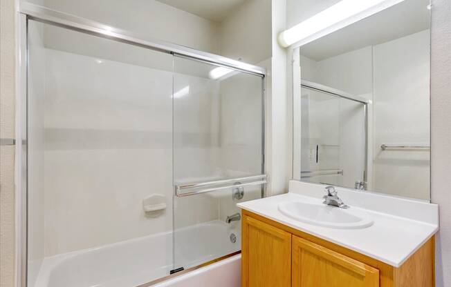 A white sink is on a counter in a bathroom.