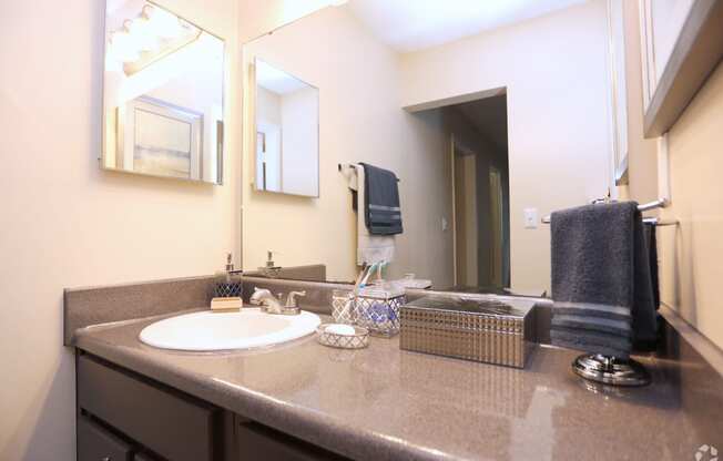 bathroom with large mirror and medicine cabinet at Harvard Place Apartments, Lithonia, GA, 30058
