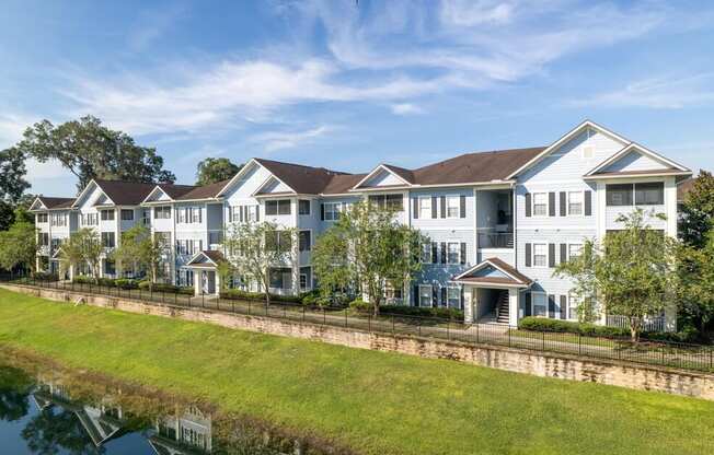 a large apartment complex with a grassy area in front of it