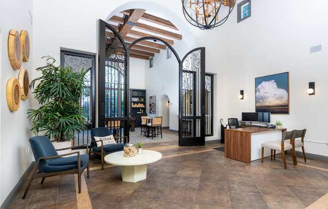 A room with a wooden floor and a white ceiling with a hanging light fixture.