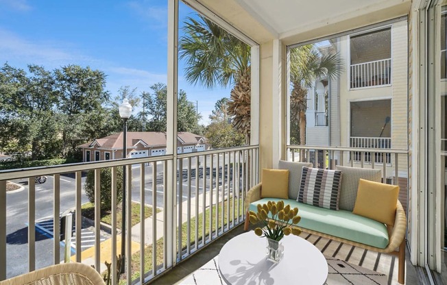 a patio with a couch and a table on a balcony