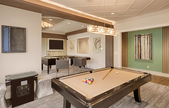 Billiard and gaming room with billiard table, Foosball and chairs