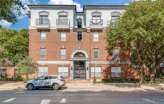 a car parked in front of a brick building