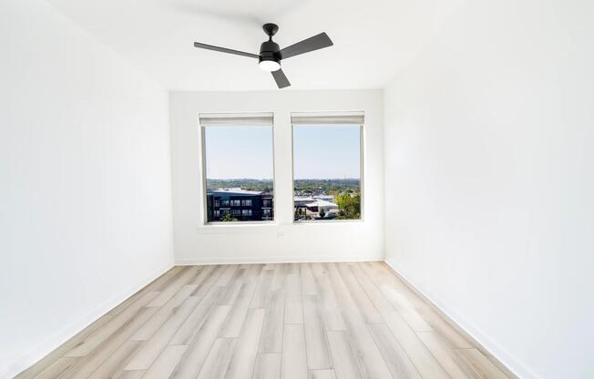 A light-filled bedroom at Modera Nations in Nashville offers calming views, clean lines, and a flexible layout designed for restful, everyday living.