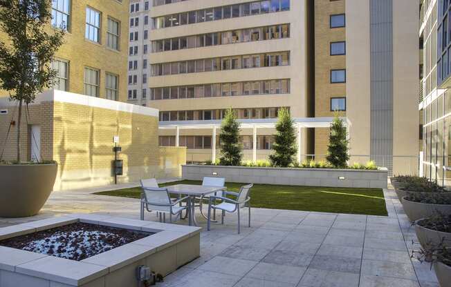 a courtyard with tables and chairs and a fountain