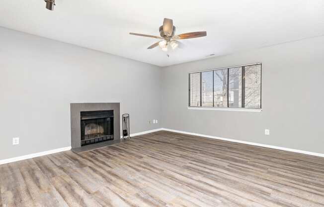 Living room with fireplace and wall art at Eddingham in Lawrence, KS