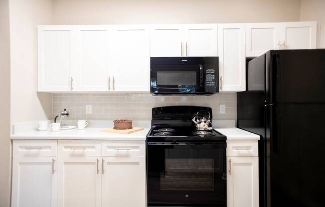 Cabinetry and Black Appliances in Kitchen at Polos at Hudson Corners Apartments, South Carolina 29650