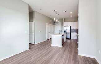 A kitchen area with a white island in the middle.