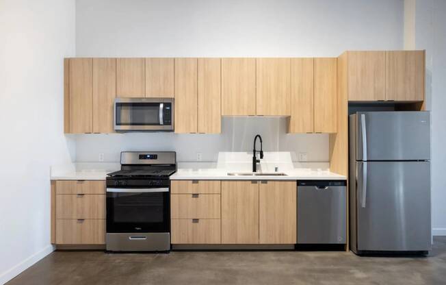 a kitchen with wooden cabinets and stainless steel appliances