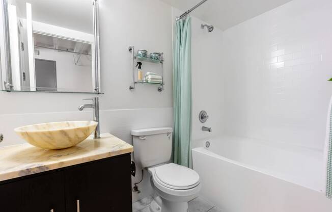 a bathroom with a sink and a toilet and a shower