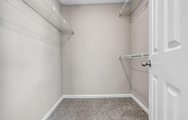 an empty closet in a home with a white door