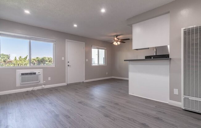 the living room and kitchen of a new home with a large window