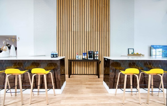 a cafe with yellow chairs and marble counters and wood floors at Presidio Palms Apartments, Arizona, 85701