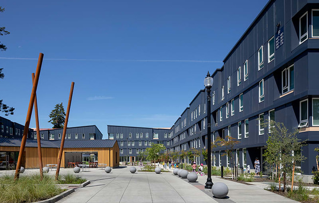 a courtyard in front of a building with a blue sky in the background