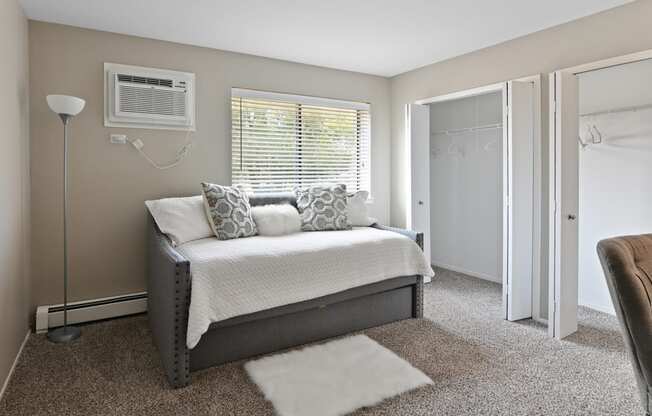 a bedroom with a bed and a chair in a 555 waverly unit