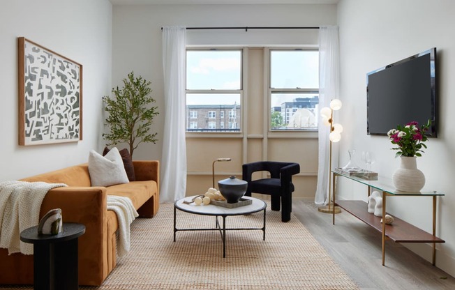 a living room with a couch and a table and a television