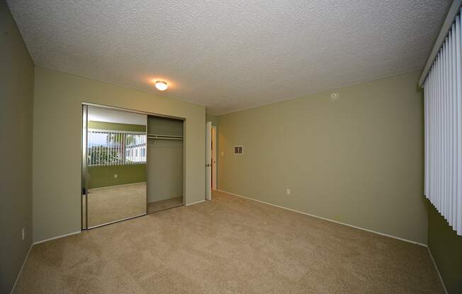 Ocean View Townhomes unfurnished bedroom with a mirror closet