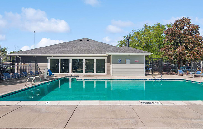 Community Swimming Pool with Pool Furniture at Overlook Apartments located in Salt Lake City, UT.