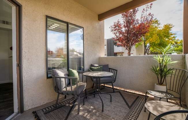 a patio with chairs and tables and a sliding glass door