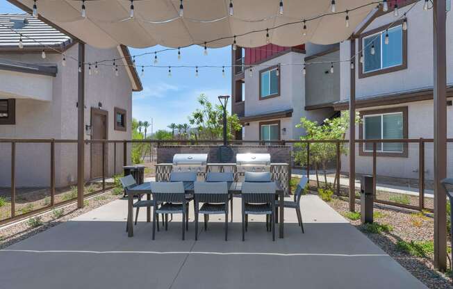 a patio with a dining table and chairs under a canopyat Weylyn Luxury Apartments, Laveen
