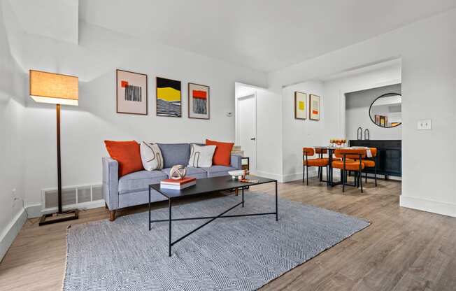 a living room with a couch and a table  at Park On Canal Apartments, Clinton Twp, 48038