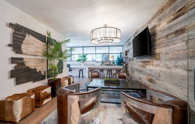 A modern living room with a wooden accent wall and a flat screen TV mounted on it.