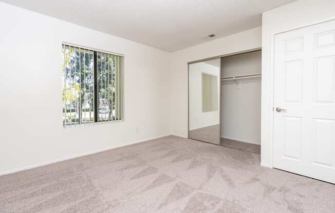 A room with a carpeted floor and a white door.