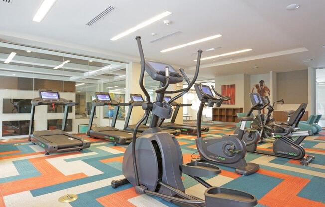 a gym with various exercise equipment in a room