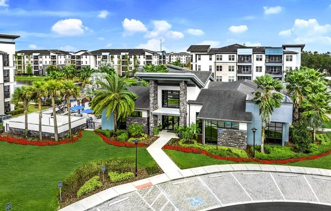 an aerial view of the property with palm trees and other buildings at Pearce at Pavilion Luxury Apartments, Riverview, FL, 33578