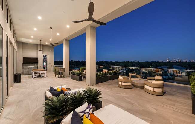 A modern outdoor living space with a view of the city skyline.