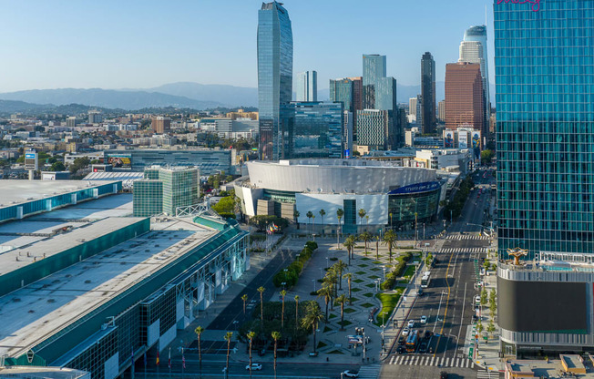 an aerial view of the los angeles convention and exhibition center with the city in the background