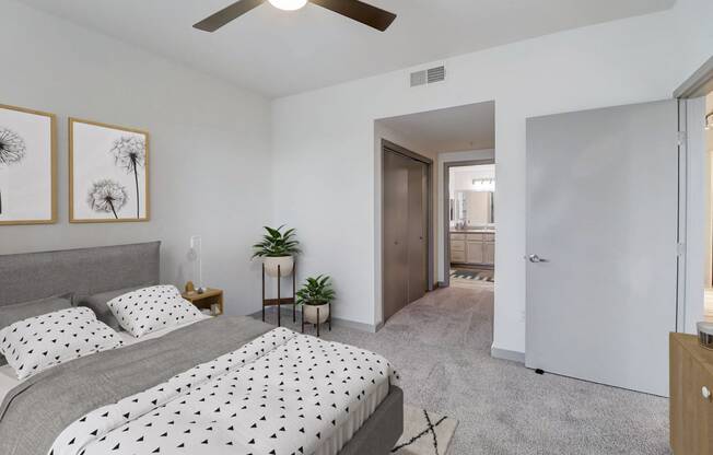 a bedroom with a bed and a ceiling fan