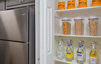 a pantry with a refrigerator next to it