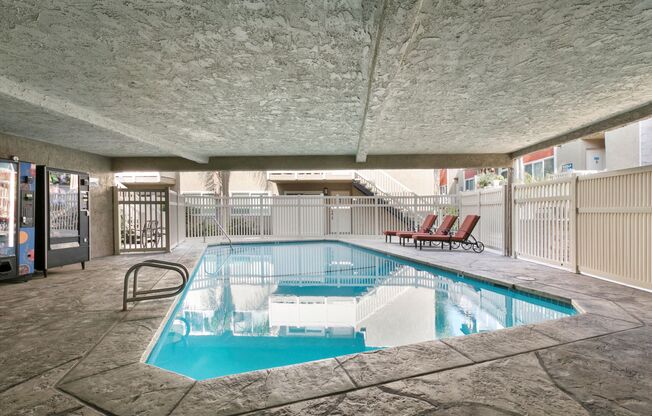 Apartments in Marina Del Rey CA - Sparkling Swimming Pool Surrounded by Lounge Chairs and Vending Machines