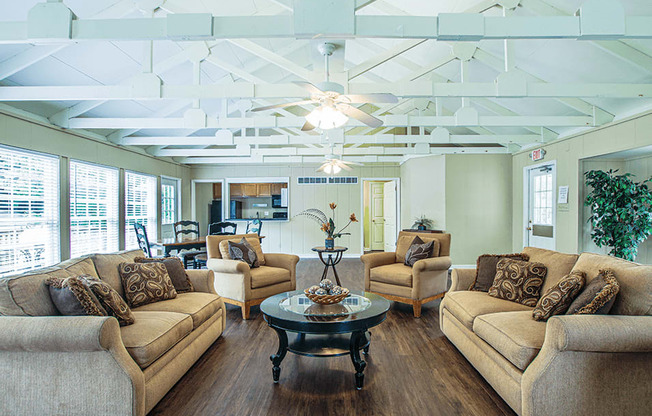 a living room with couches chairs and a coffee table
