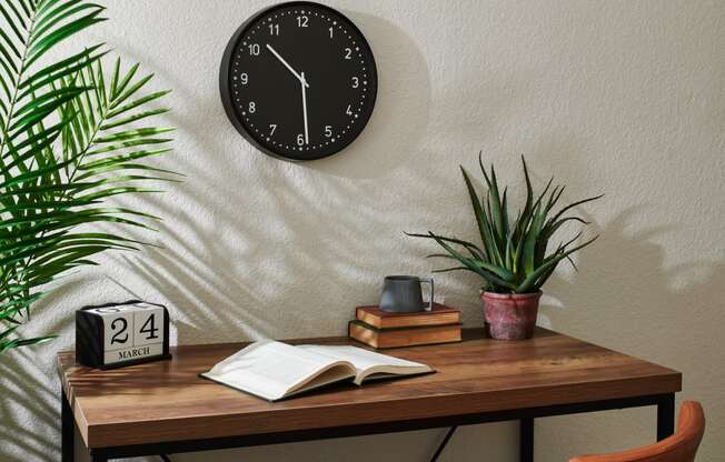 a desk with a clock and plants on top of it