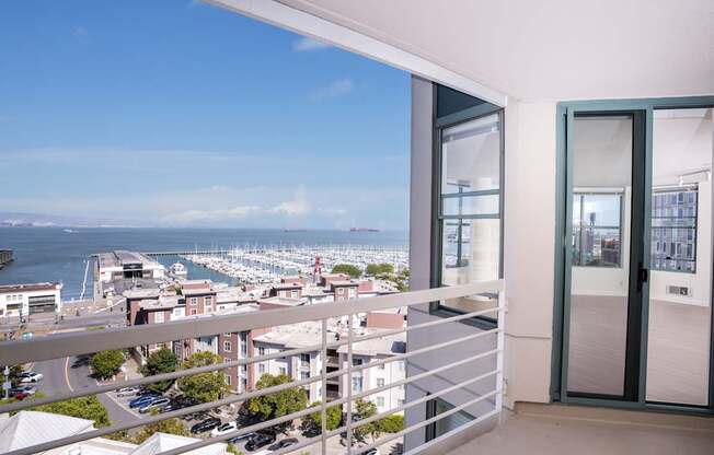 A balcony with a view of a harbor and buildings.