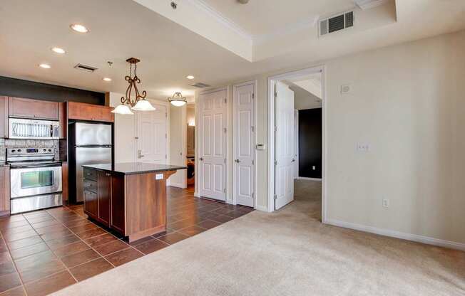A kitchen with a refrigerator, oven, and microwave.