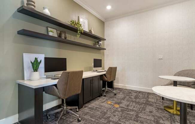 Resident Business Lounge with two desks and two computer monitors at Madison on the Meadow, Stafford, Texas