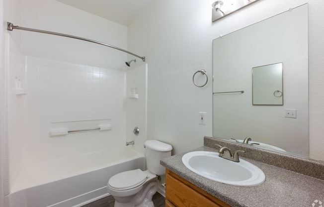 A white toilet and sink in a bathroom.