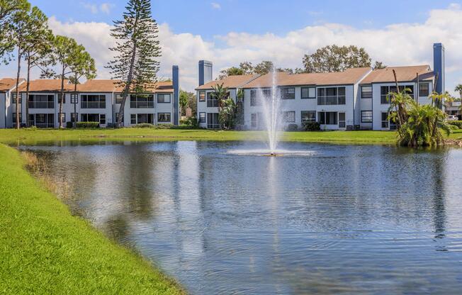 a building with a pond in front of a body of water