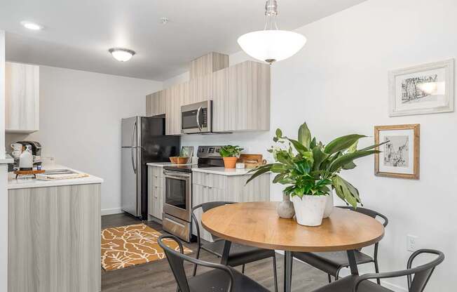 a kitchen and dining area with a table and chairs and a refrigerator