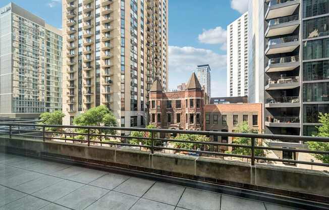 A view of a cityscape with modern buildings and a bridge.