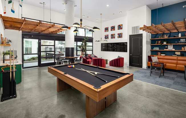 a games room with a pool table and a tv