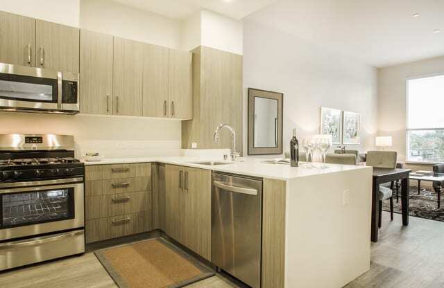 Kitchen with stainless steel appliances and dining area