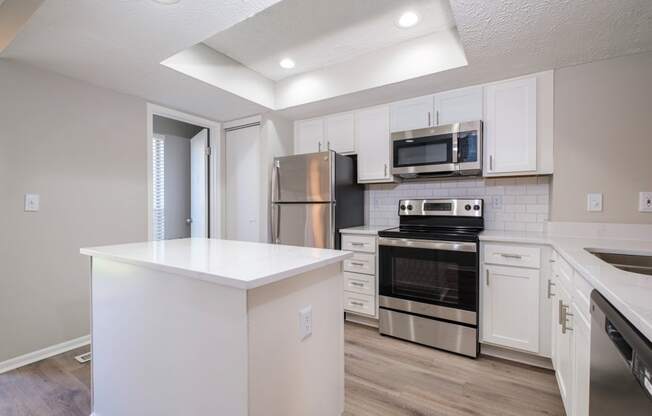 Perimeter Lakes apartments kitchen with white cabinets and stainless appliances