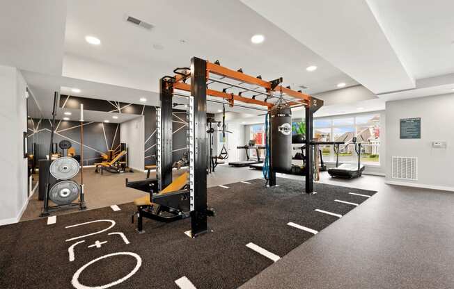 a gym with weights machines and other exercise equipment on a carpeted floor