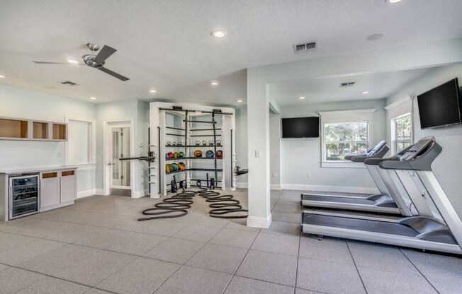Fitness Center with two tv's, treadmills, medicine balls and ropes